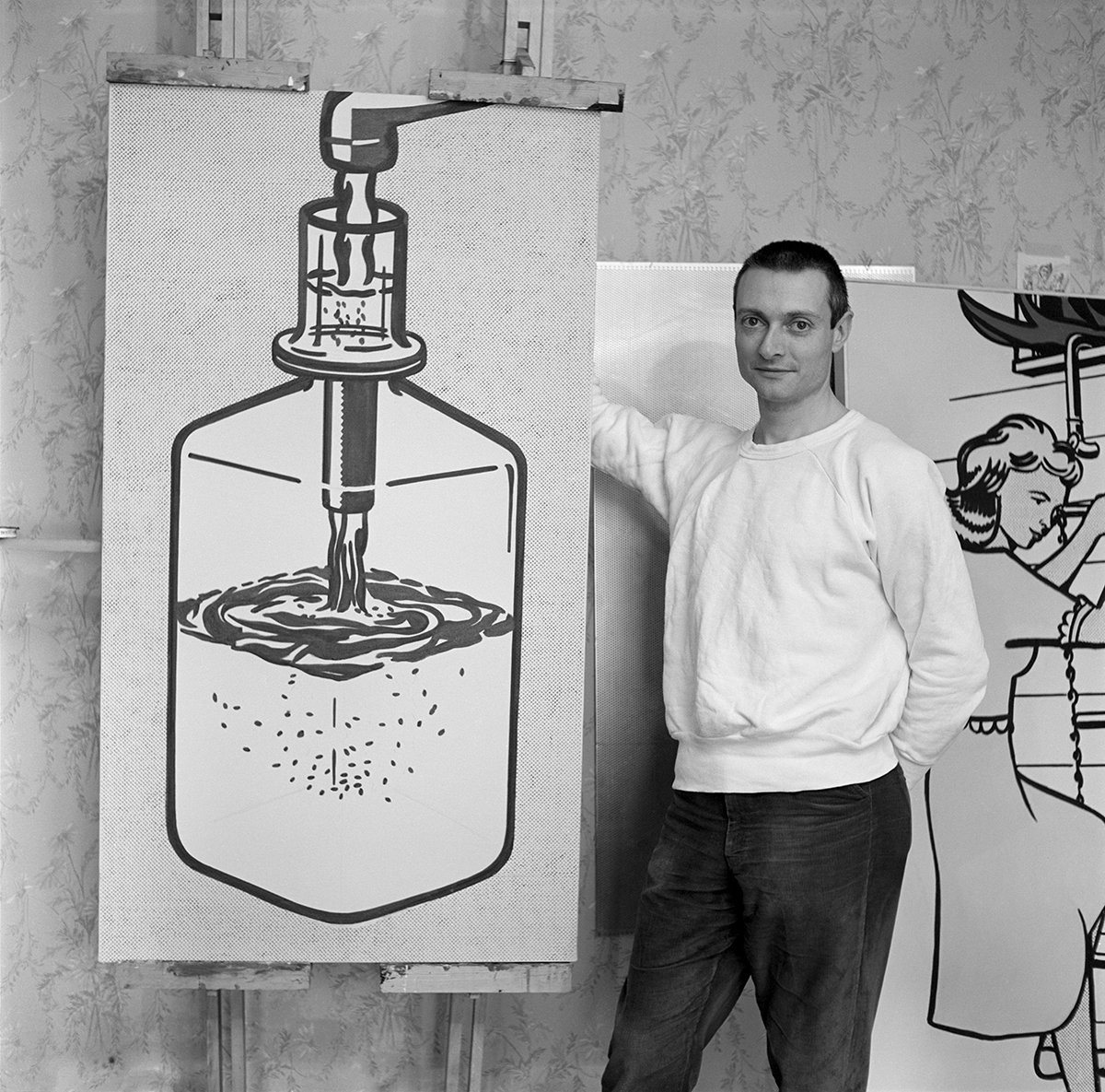 The artist posing at his Highland Park studio in 1962 with RLCR 677, Blue Bottle. Photo: Ben Martin, courtesy Ben Martin Archive; Artwork © Estate of Roy Lichtenstein